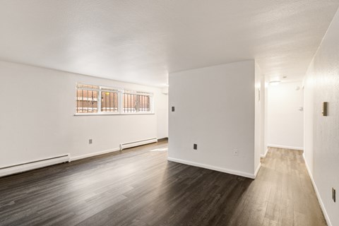 A room with wooden floors and white walls.