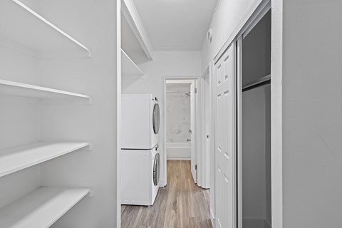 A white laundry room with a washer and dryer.