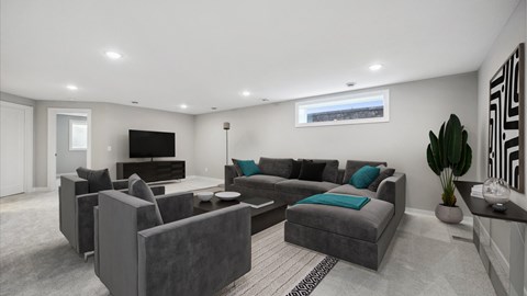 A modern living room with grey furniture and a flat screen TV.