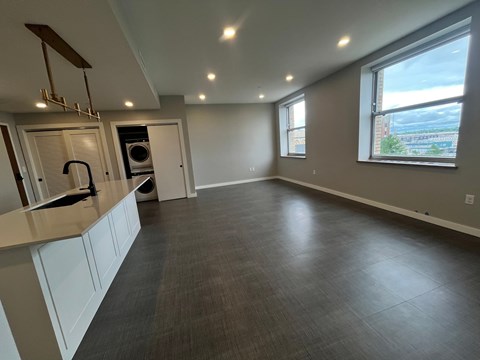 A spacious kitchen with white cabinets and a large island.