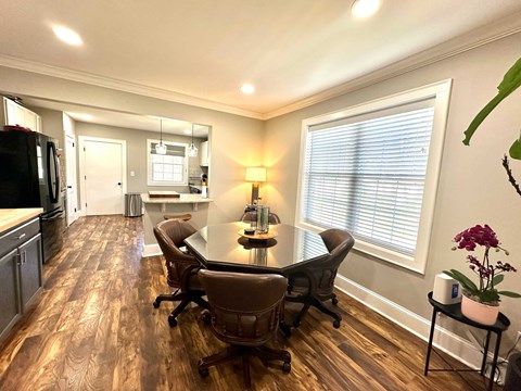 A kitchen with a table and chairs in the middle of the room.