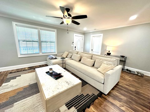 A living room with a white couch and a coffee table.