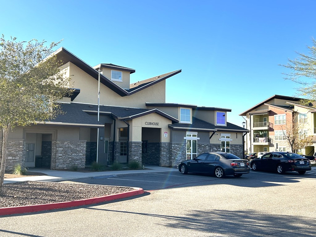 A car dealership with two cars parked in front.