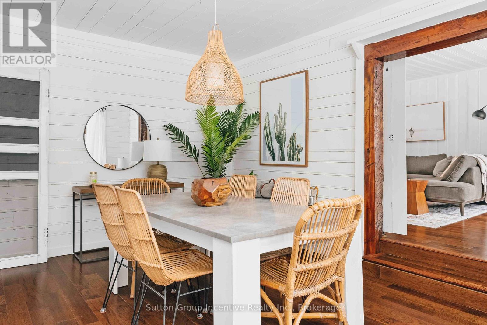 A dining room with a white table and chairs.