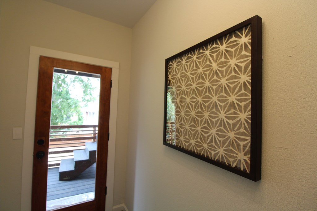 A picture with a geometric pattern is hanging on a wall.