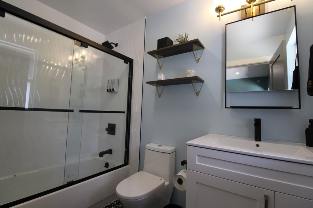 A white toilet sits next to a sink in a bathroom.