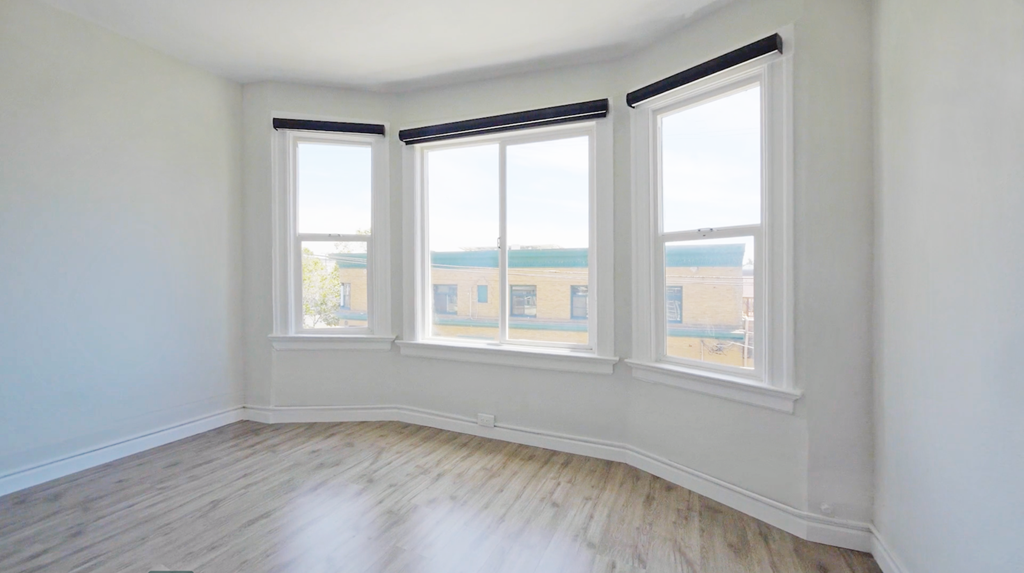 A room with a view of the outside through the windows.