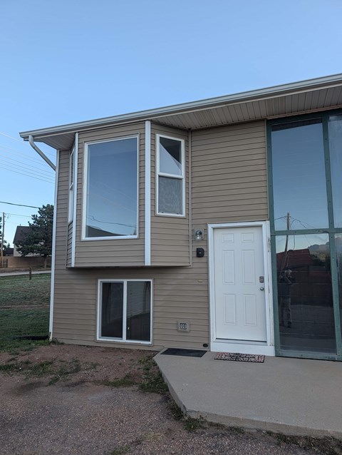 A house with a white door and windows.