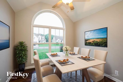 A dining room with a table set for a meal.