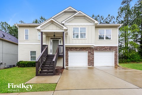 A two-story house with a garage is for sale.