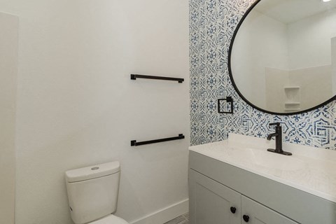 A white toilet sits next to a sink in a bathroom.