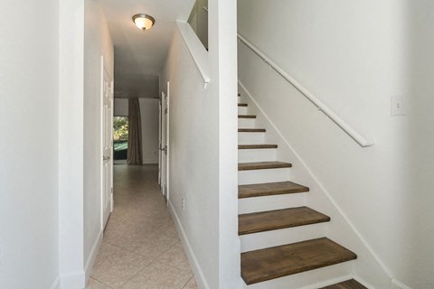 A long hallway with a staircase on the right side.