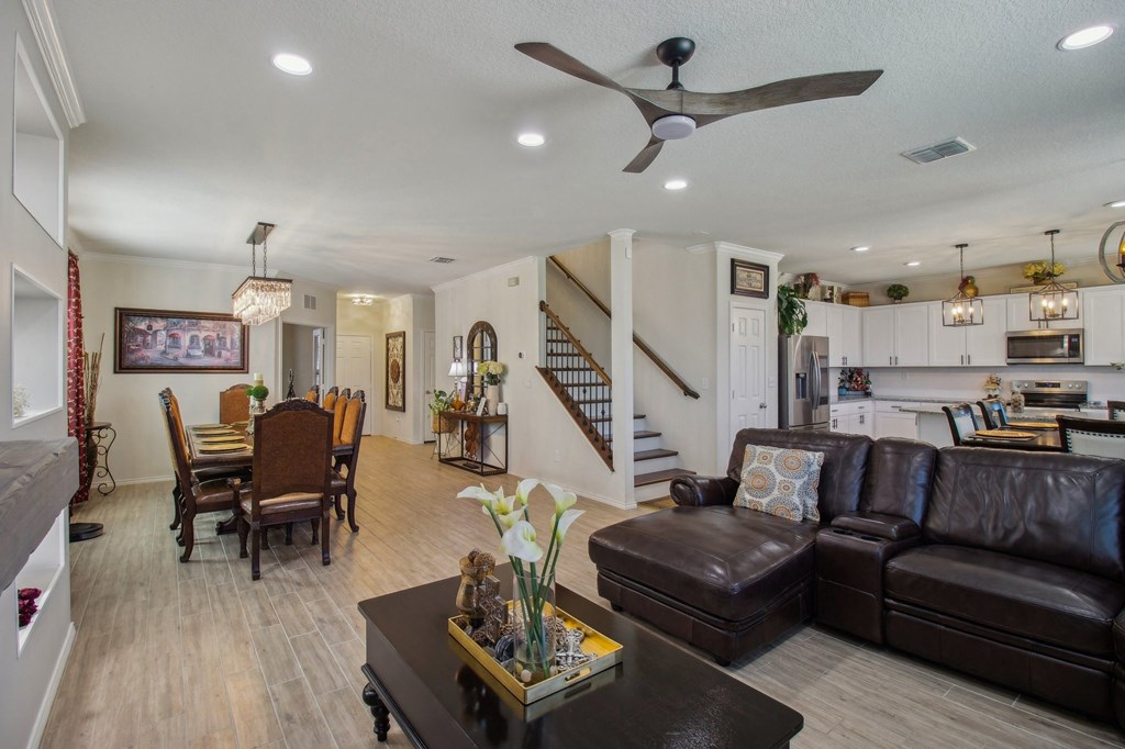 A living room with a brown leather couch and a wooden coffee table.