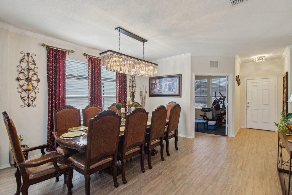 A dining room with a long table and chairs.