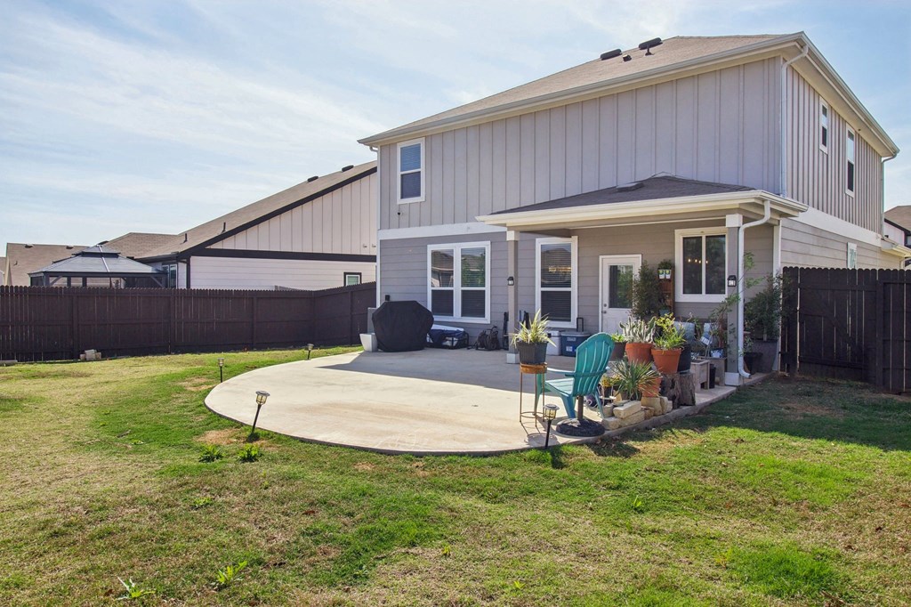 A house with a grey roof and a white fence.