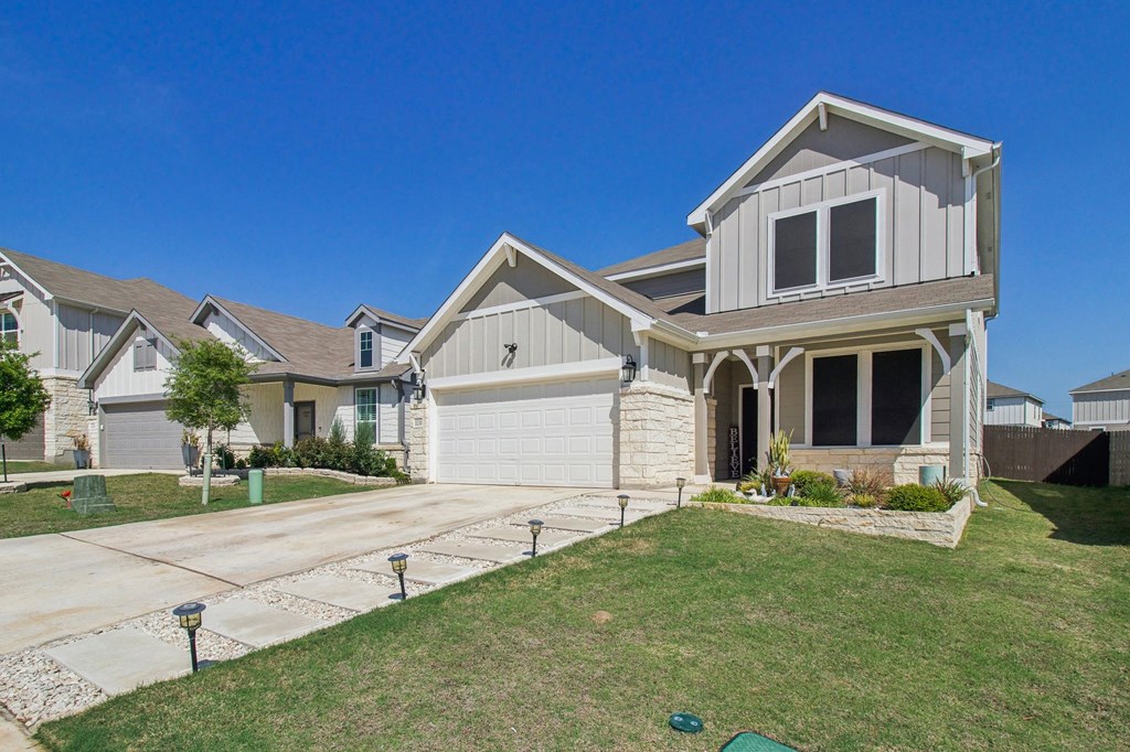 A large house with a garage and a driveway.