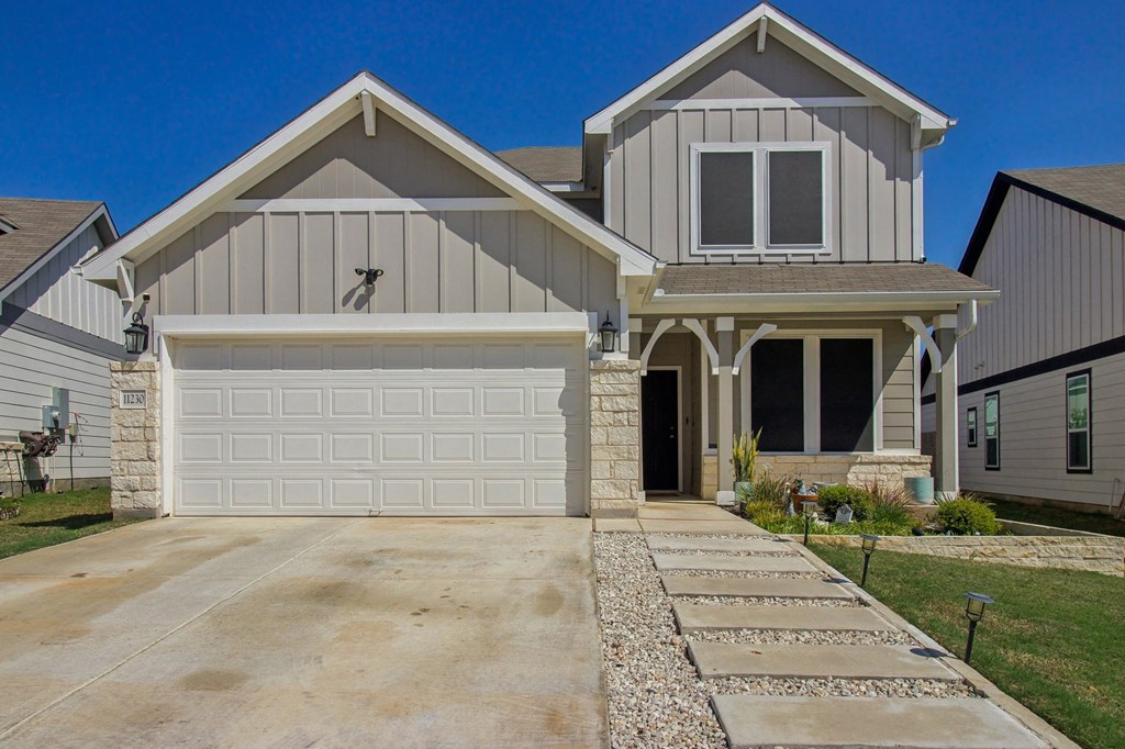 A house with a garage and a driveway.