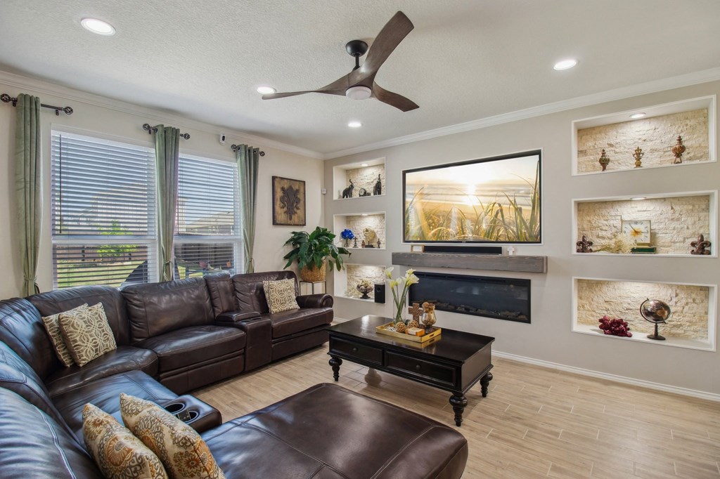 A living room with a brown leather couch and a coffee table.