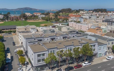 A view of a residential area with houses and cars.