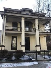 A two-story house with a black door and windows.
