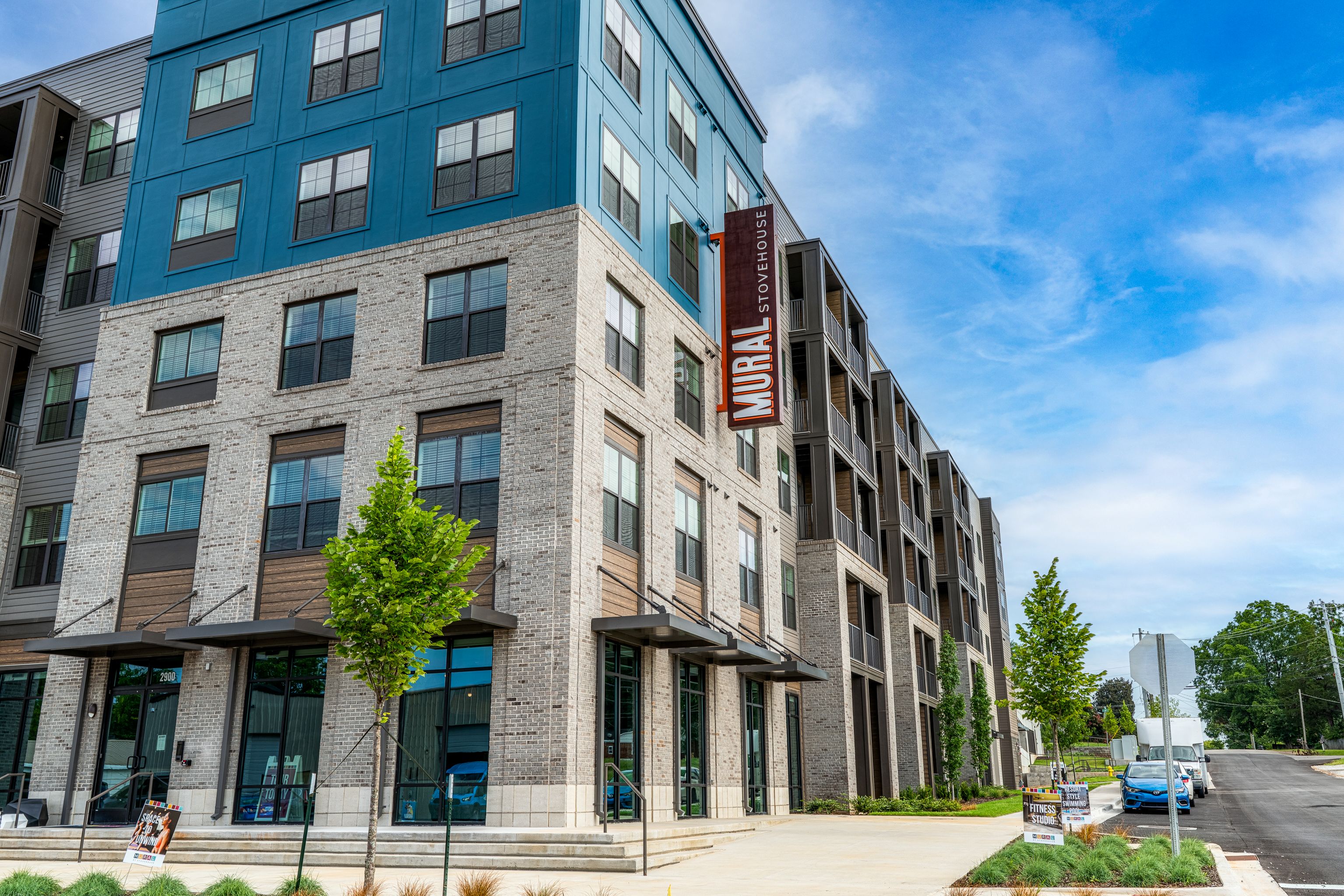A modern apartment building with a blue sky in the background.