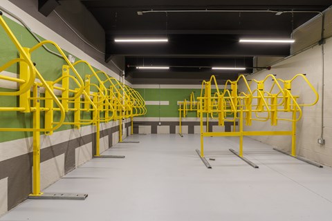 A gym with yellow handles and green walls.