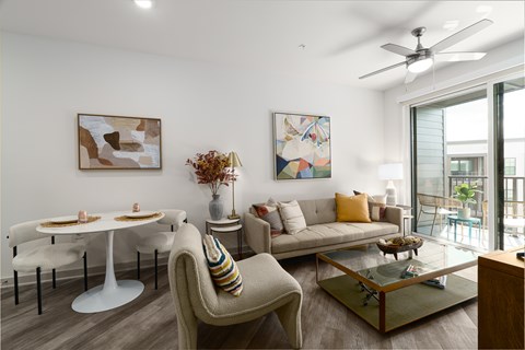 A living room with a white table and a beige couch.