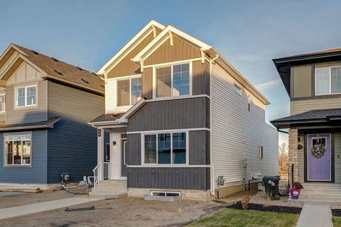 A row of houses with different colors and designs.