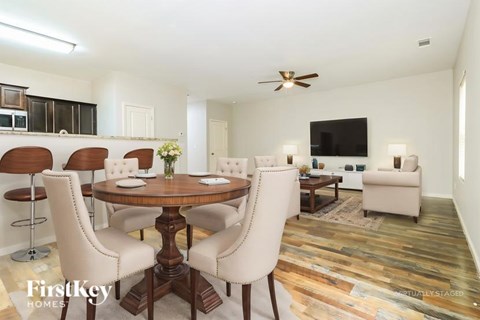 A dining room with a wooden table and chairs.