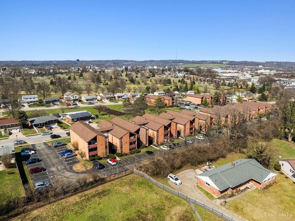 A large building complex with a parking lot in front.