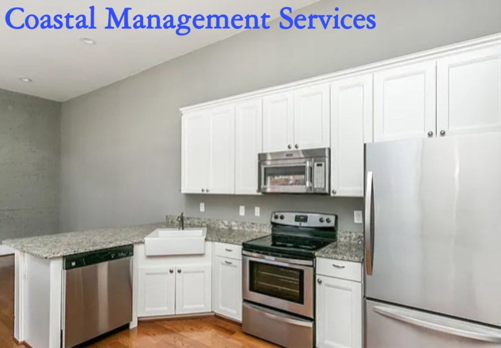 A kitchen with white cabinets and stainless steel appliances.