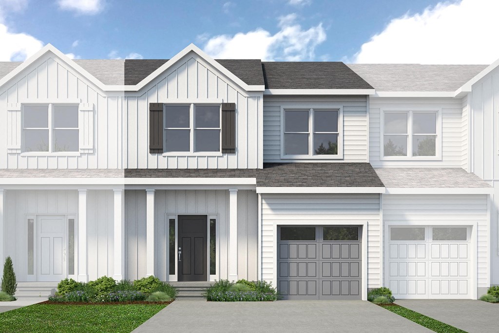 A white house with a black door and windows.