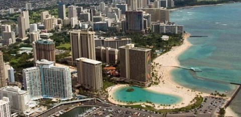 A cityscape with a beach in the foreground.