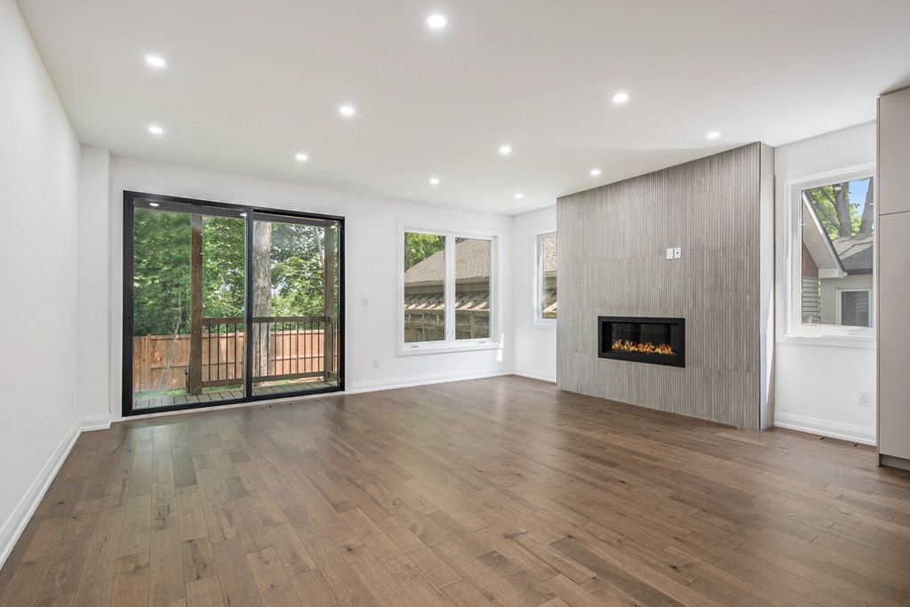 A modern living room with a fireplace and sliding glass doors.
