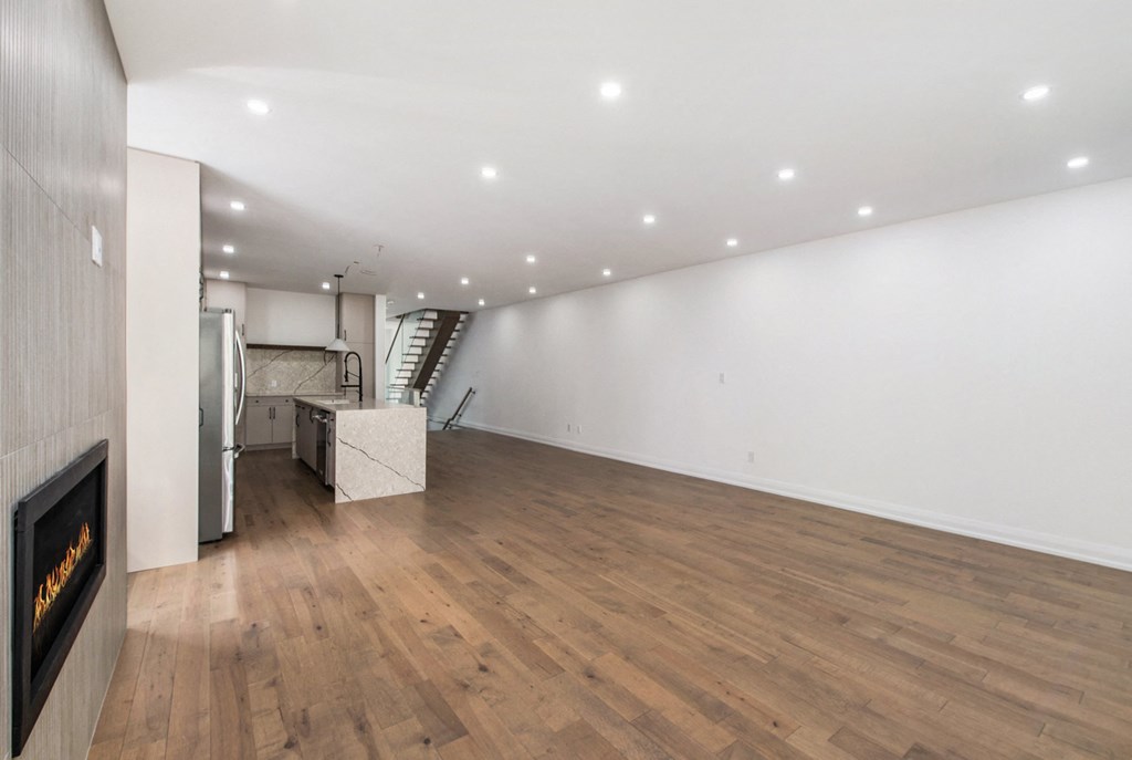 A room with a fireplace and wooden floors.