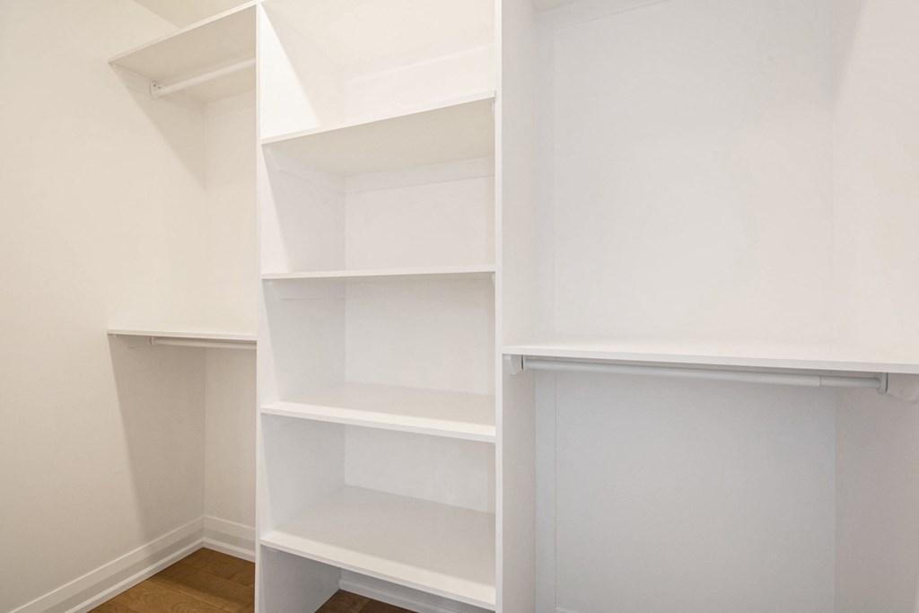 Empty white shelves in a room.