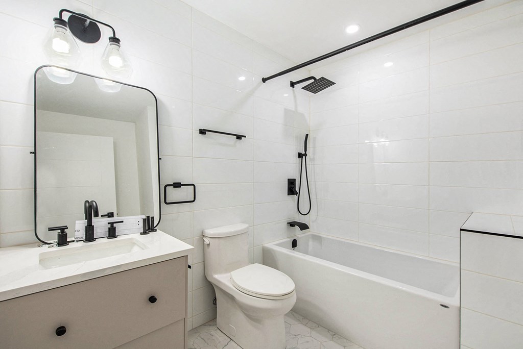 A white bathroom with a sink, toilet, and bathtub.