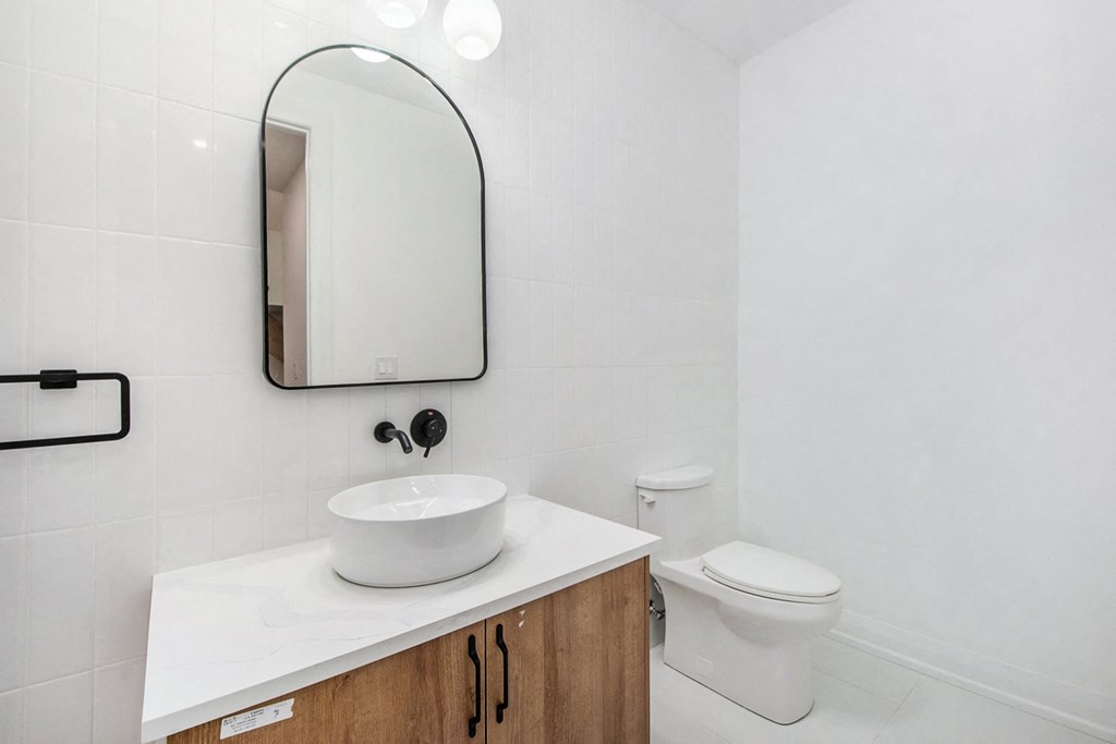 A white sink is on a countertop in a bathroom.