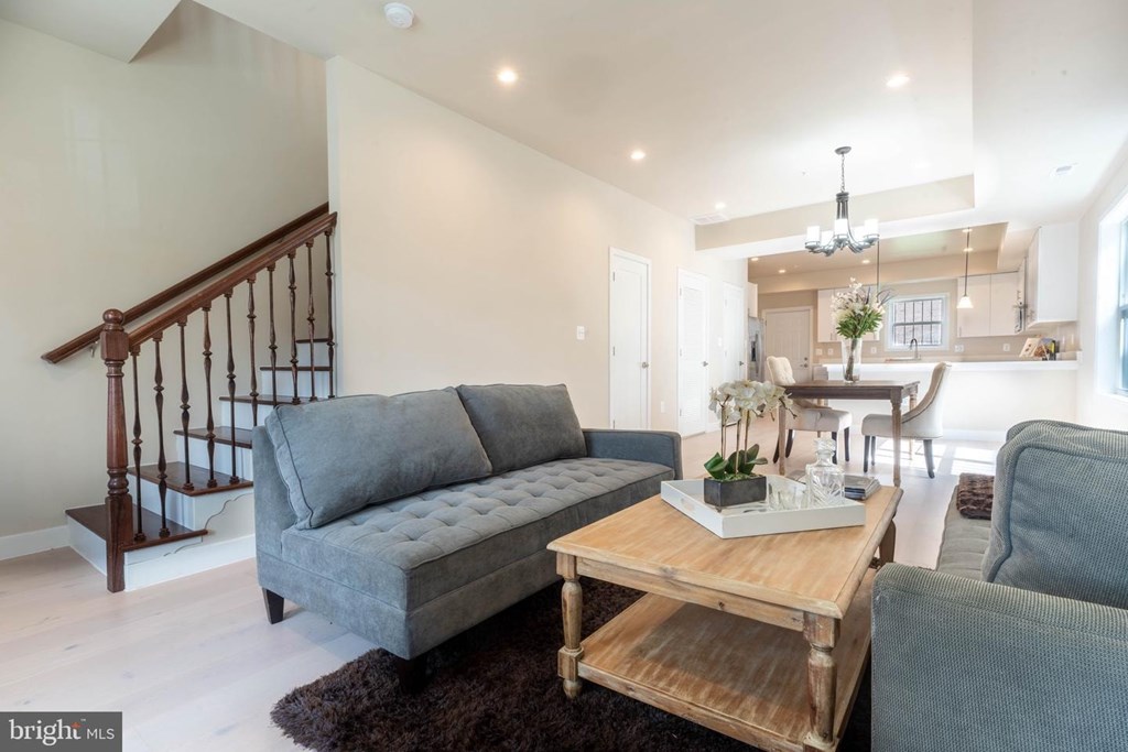 A living room with a grey couch and a wooden coffee table.