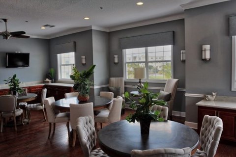 A living room with a dining table and chairs.