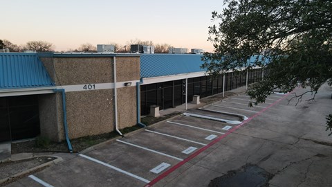 A parking lot with the number 401 on a wall.