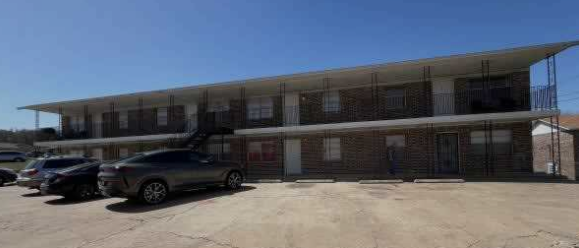 A car is parked in front of a building.