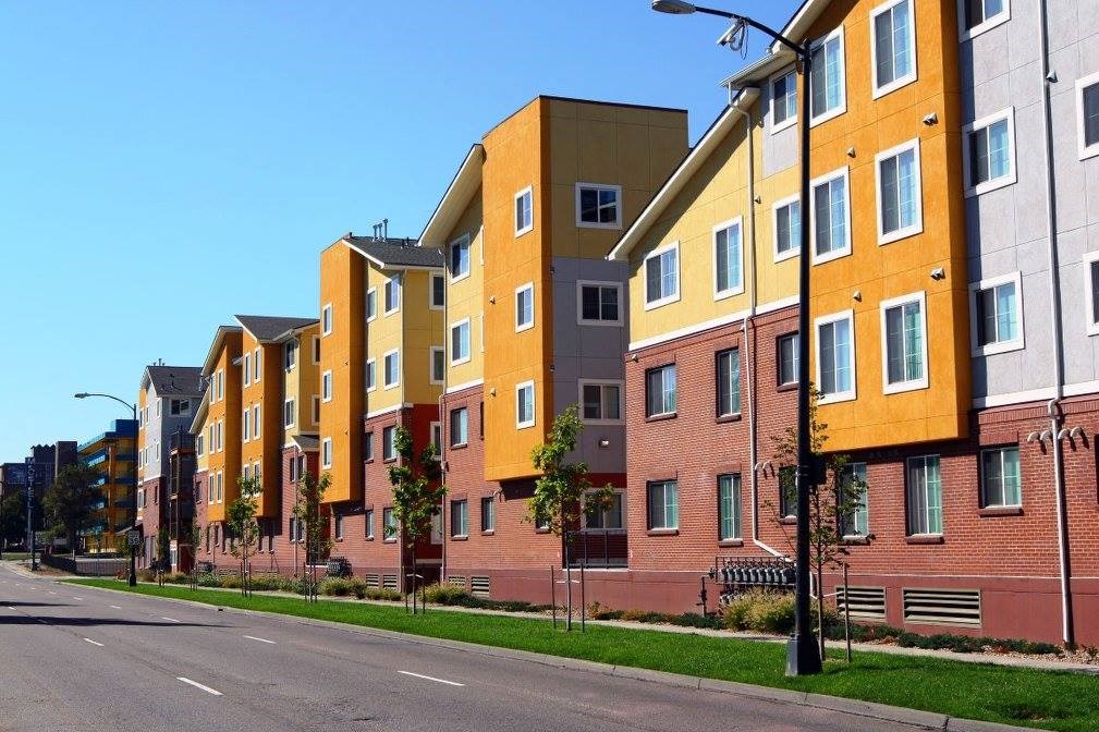 A street view of a row of modern apartment buildings.