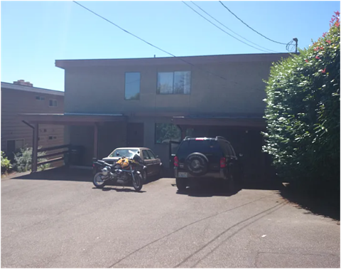 A motorcycle is parked in front of a house.