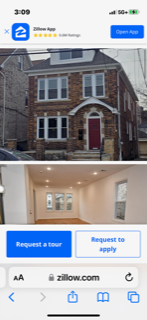 A house with a red door and a sign that says "Request a tour".