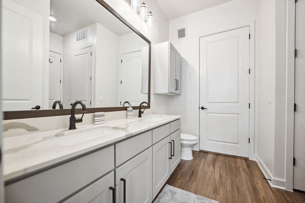 A white bathroom with a toilet and sink.