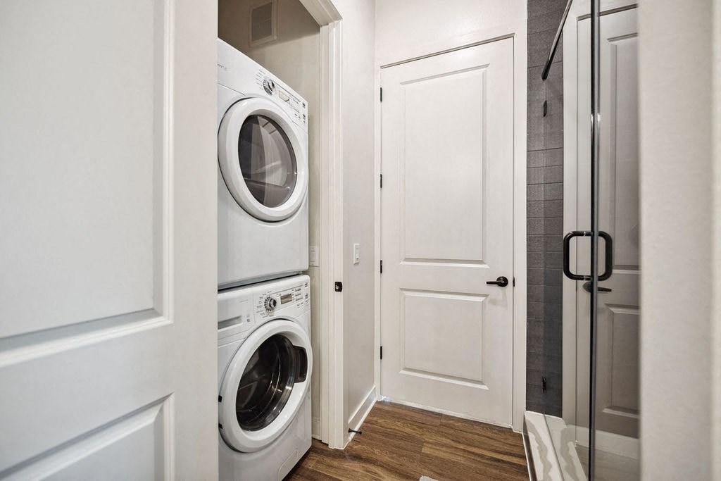 A white washing machine is in a small laundry room.