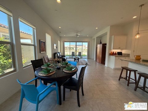 A dining room with a table set for a meal.