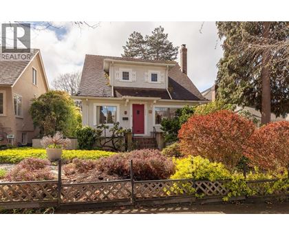 A white house with a gravel pathway leading to the front door.