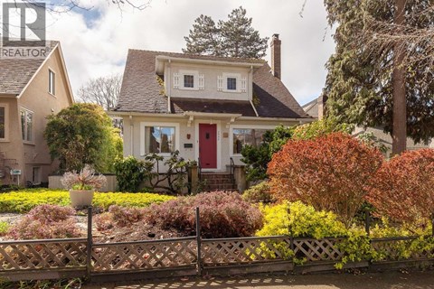 A white house with a gravel pathway leading to the front door.